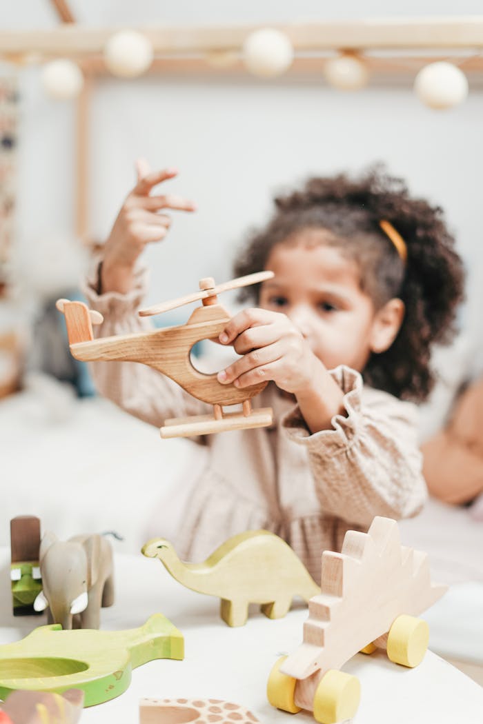 about-03 Child having fun with wooden toys in a playroom setting.